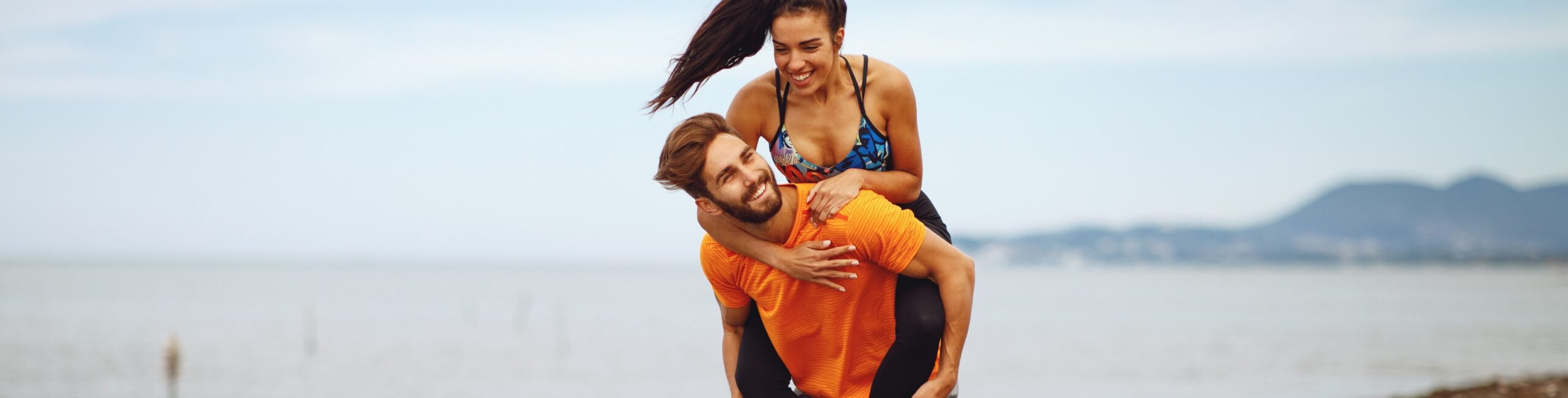 young-couple-enjoying-the-beach-after-workout-2023-11-27-05-02-53-utc (1)